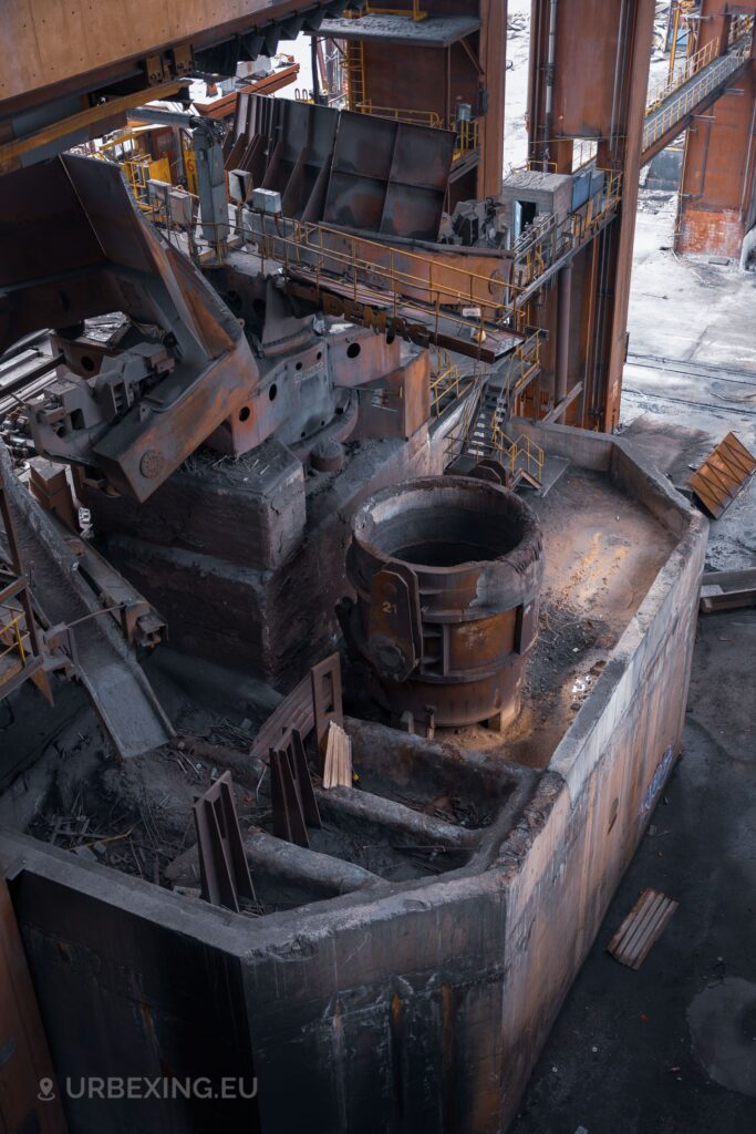 a photograph of a ladle standing under a DEMAG continuous casting machine in the abandoned liege steelworks