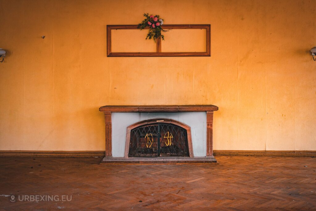 a photo of a fireplace in an abandoned building, the fireplace has the year 1954 written on it