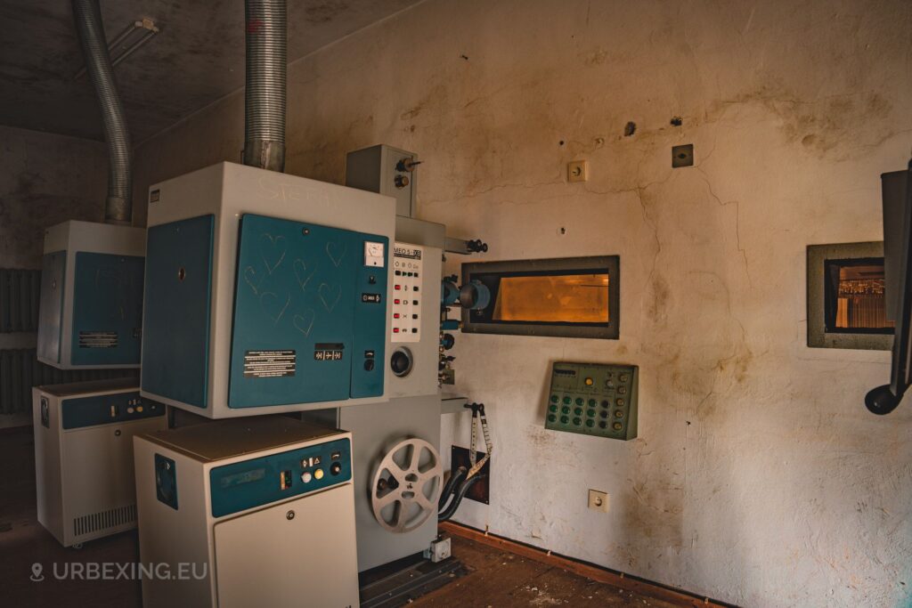 a photo of two large old projectors in an abandoned theatre found during urban exploration