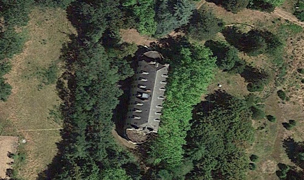 a satellite images showing an abandoned house in a forested area