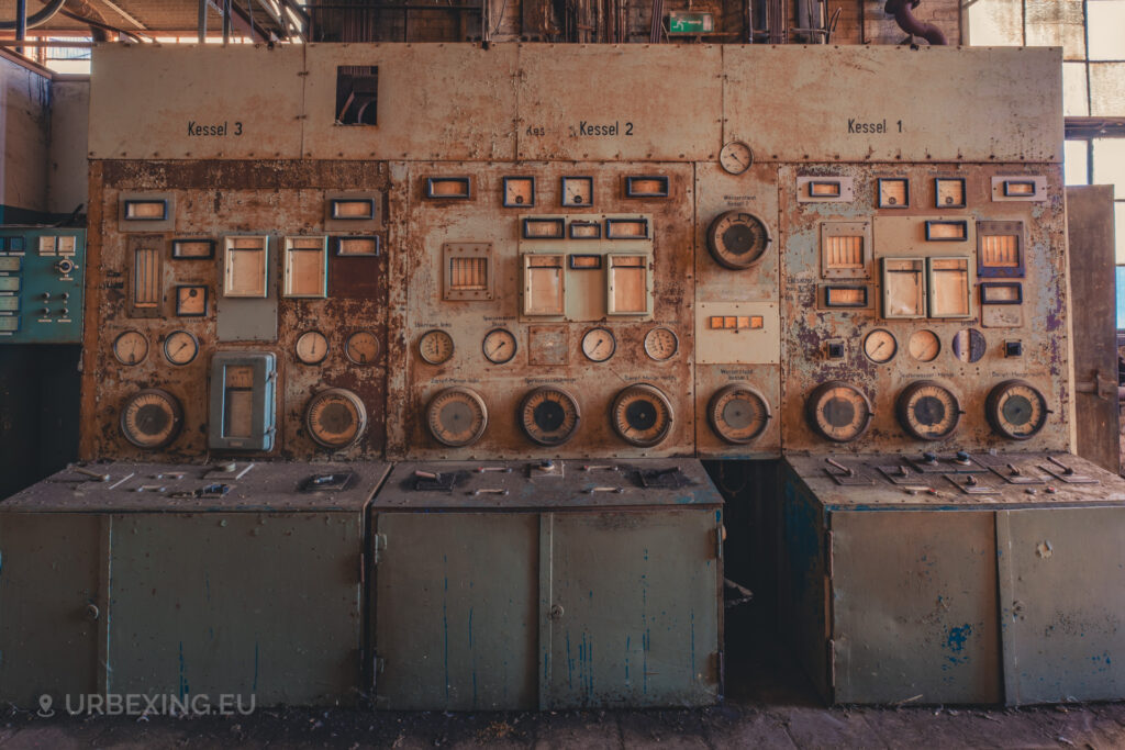 a photograph of a control panel in a former power plant. the panel is to control the boilers. the text is in german and is labaled kessel 1,2 and 3