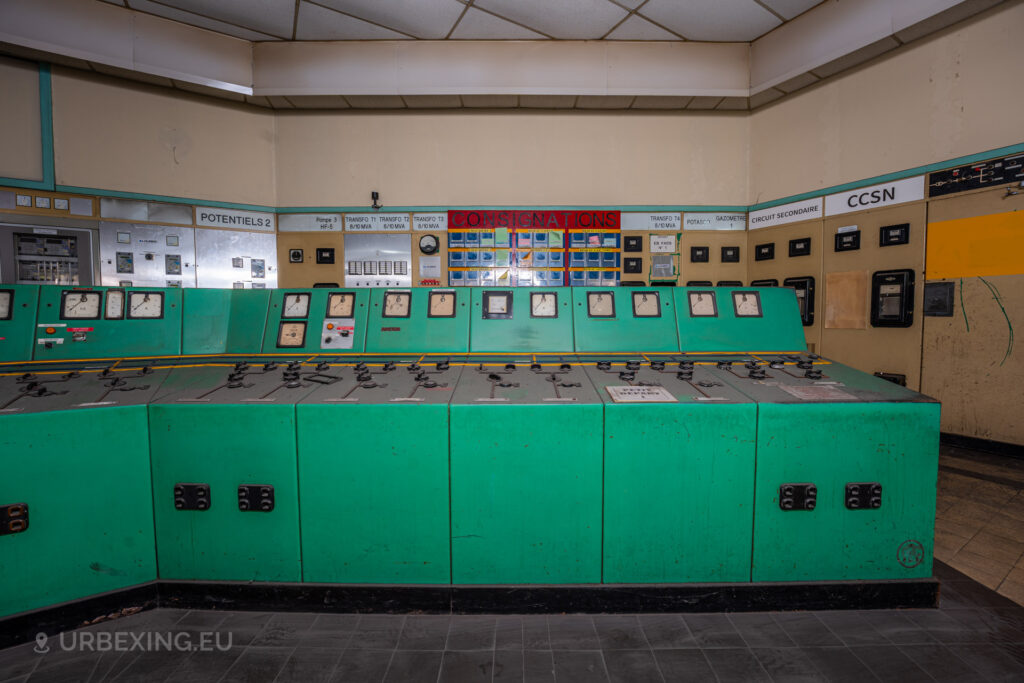 a photograph taken in at an urbex location called blue power plant. the photograph shows a close up view of the right part of the blue control panel in the control room. many buttons and meters can be seen.