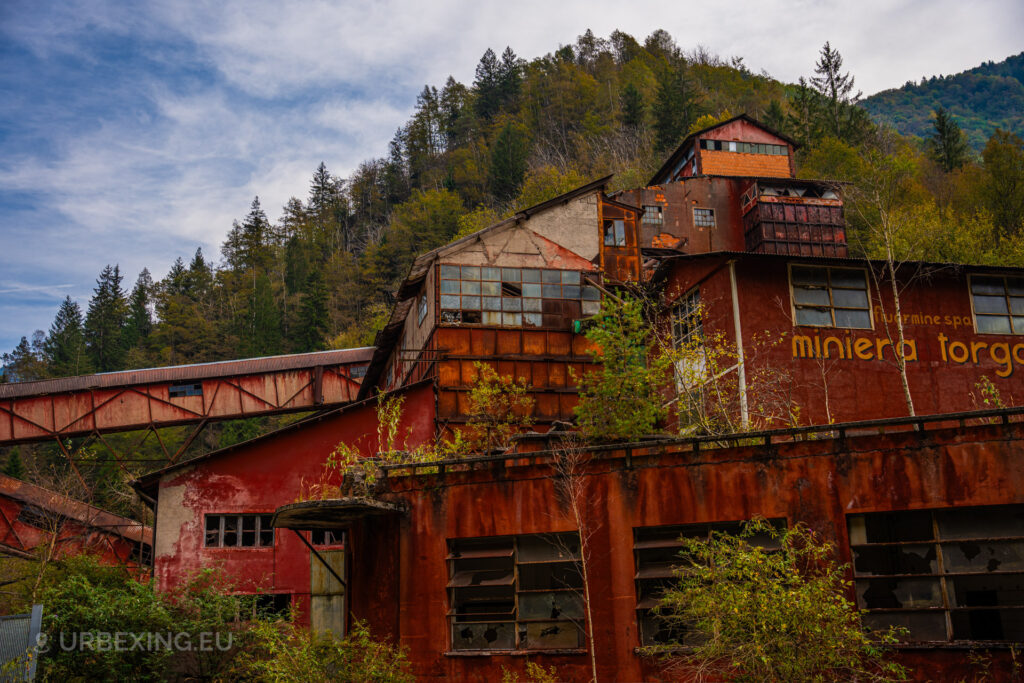a photograph of the abandoned fluorite mine miniera torgola. also known as red urbex mine.