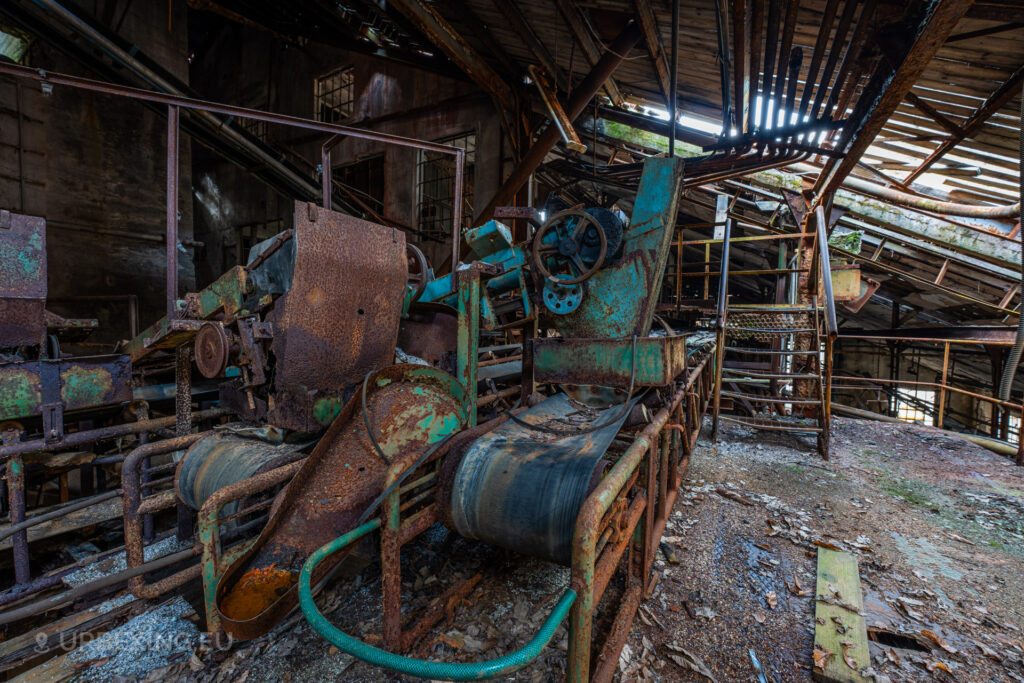 A photograph of conveyor belts inside an abandoned fluorite mine called miniera torgola.