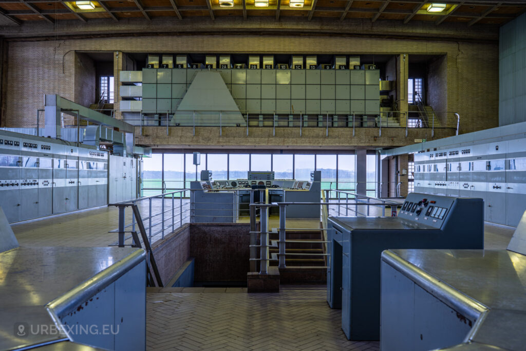 A panoramic shot of the "Lost Frequencies" control room, highlighting the control panels, switches, and gauges. The room's expansive layout and vintage equipment make it a perfect subject for urban exploring enthusiasts looking to capture the history of abandoned technology.