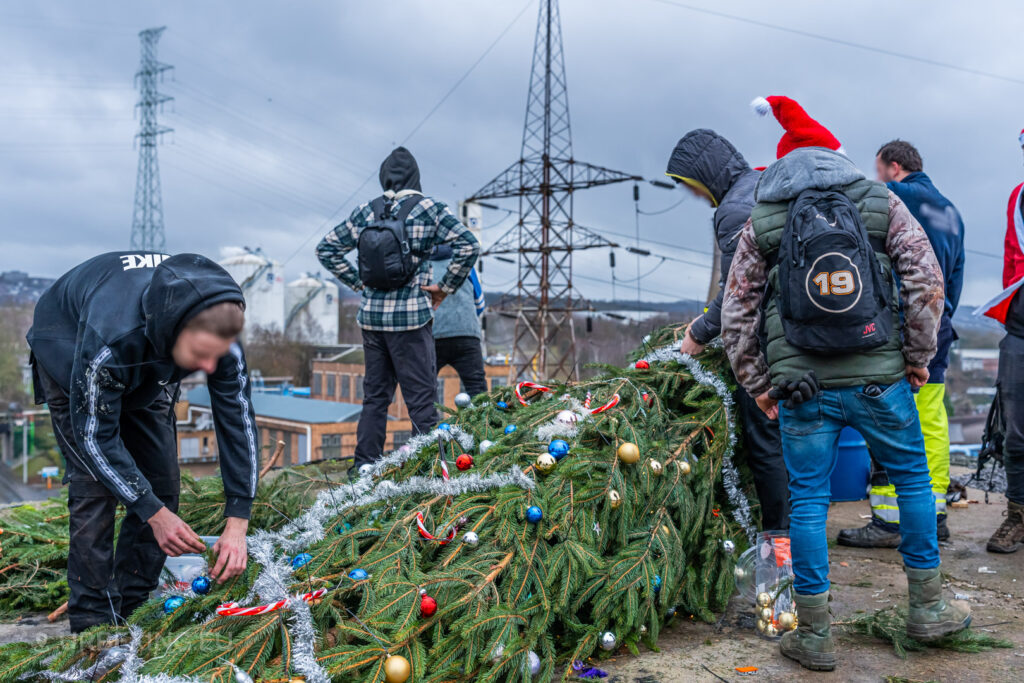 Urban explorers bring holiday cheer to the rooftop of the abandoned HF6 power plant in Seraing, Belgium, decorating a Christmas tree amidst the industrial skyline.