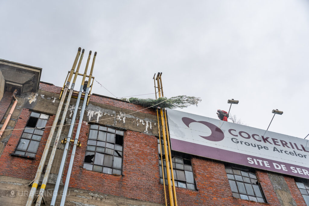 Urban explorers successfully pull a Christmas tree onto the rooftop of the abandoned HF6 power plant in Seraing, Belgium, adding a festive touch to this decayed industrial site.