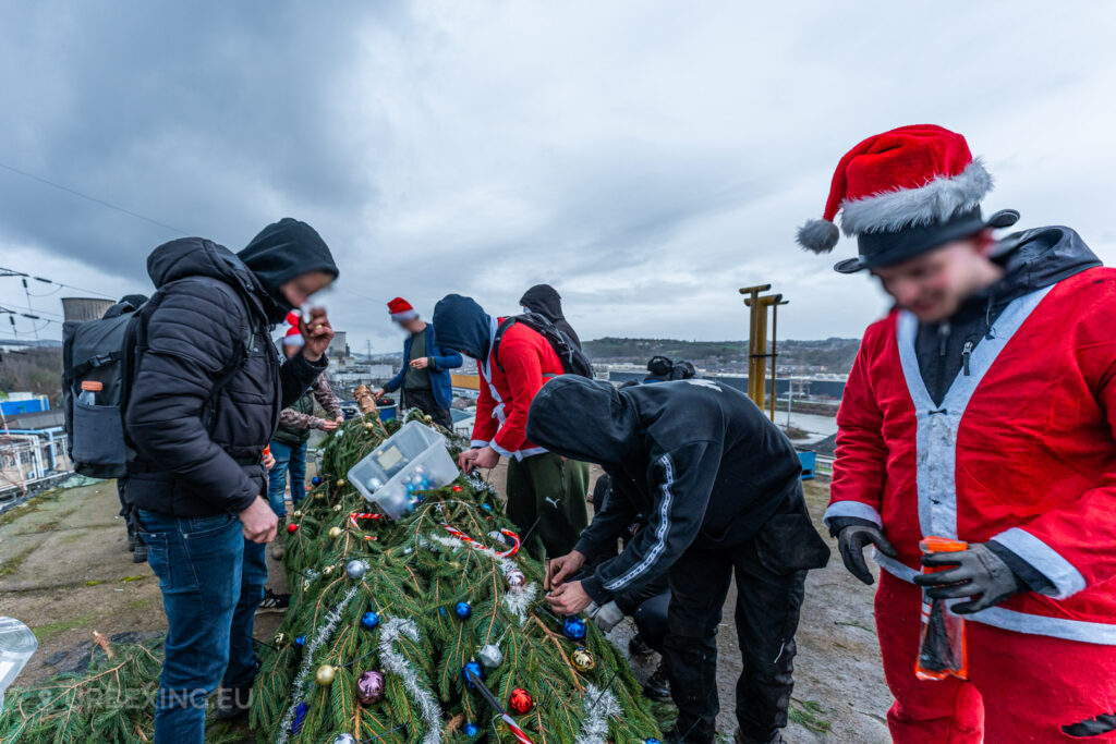 Urban explorers add ornaments and tinsel to a Christmas tree on the rooftop of the abandoned HF6 power plant in Seraing, Belgium, blending festive spirit with the rugged charm of urban exploration.