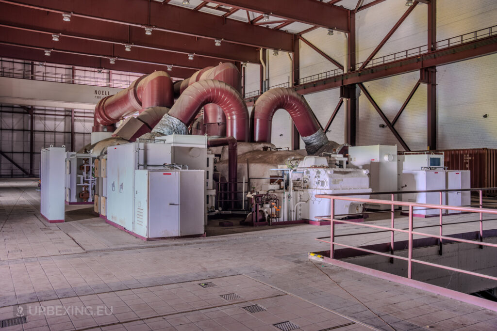 Angled view of red turbines and industrial equipment in the abandoned Kraftwerk Voerde, Voerde, Germany.