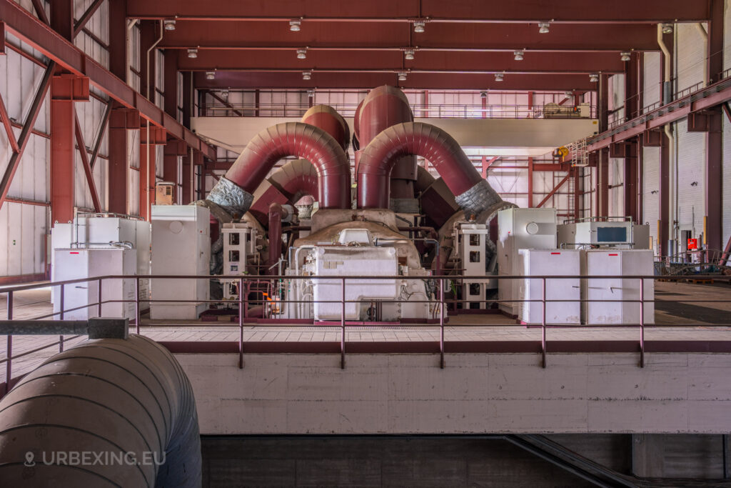 Front view of red industrial turbines and machinery in the abandoned Kraftwerk Voerde, Voerde, Germany.