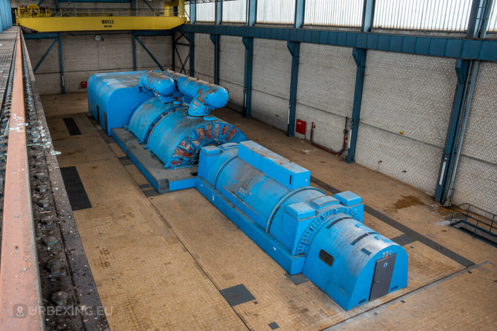 Overhead view of blue BBC turbine generators with a yellow crane in the abandoned Kraftwerk Voerde, Voerde, Germany.