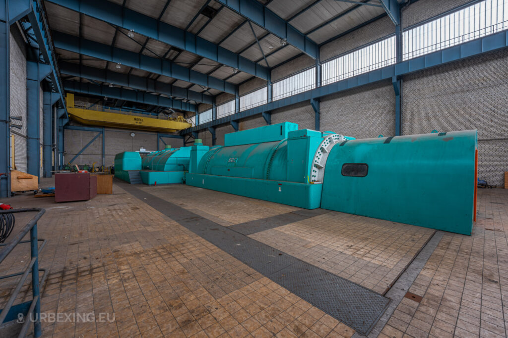 Side view of a turquoise BBC generator in the turbine hall of the abandoned Kraftwerk Voerde, Voerde, Germany.