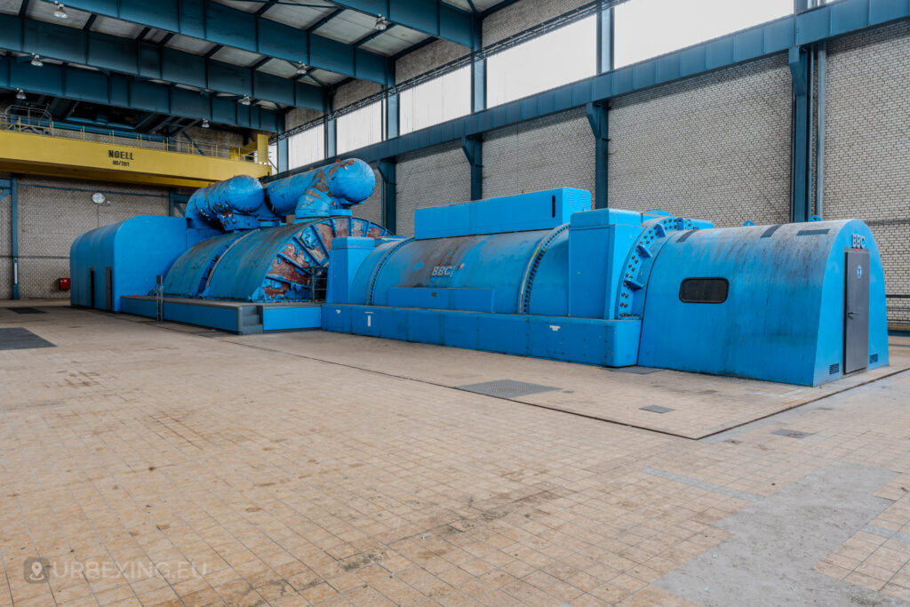 Side view of a large blue BBC turbine generator in the turbine hall of the abandoned Kraftwerk Voerde, Voerde, Germany.