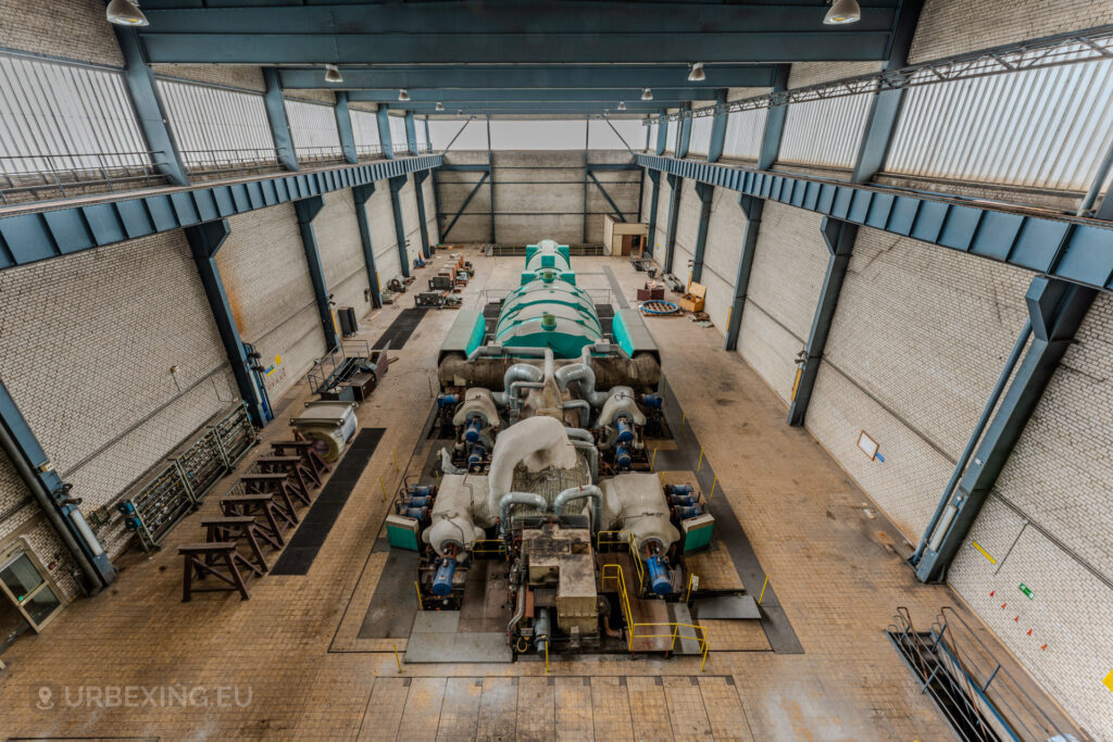 Spacious turbine hall with a large green generator in the abandoned Kraftwerk Voerde power station, Voerde, Germany