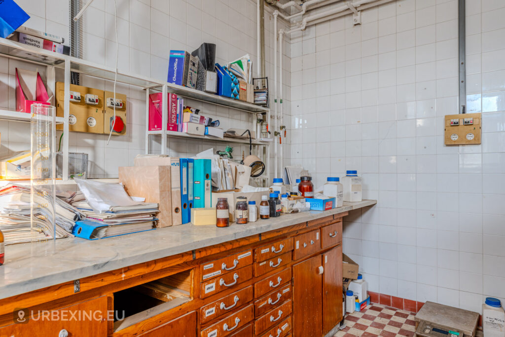 Photograph of chemicals and papers on a desk in an abandoned chemical plant in Hungary