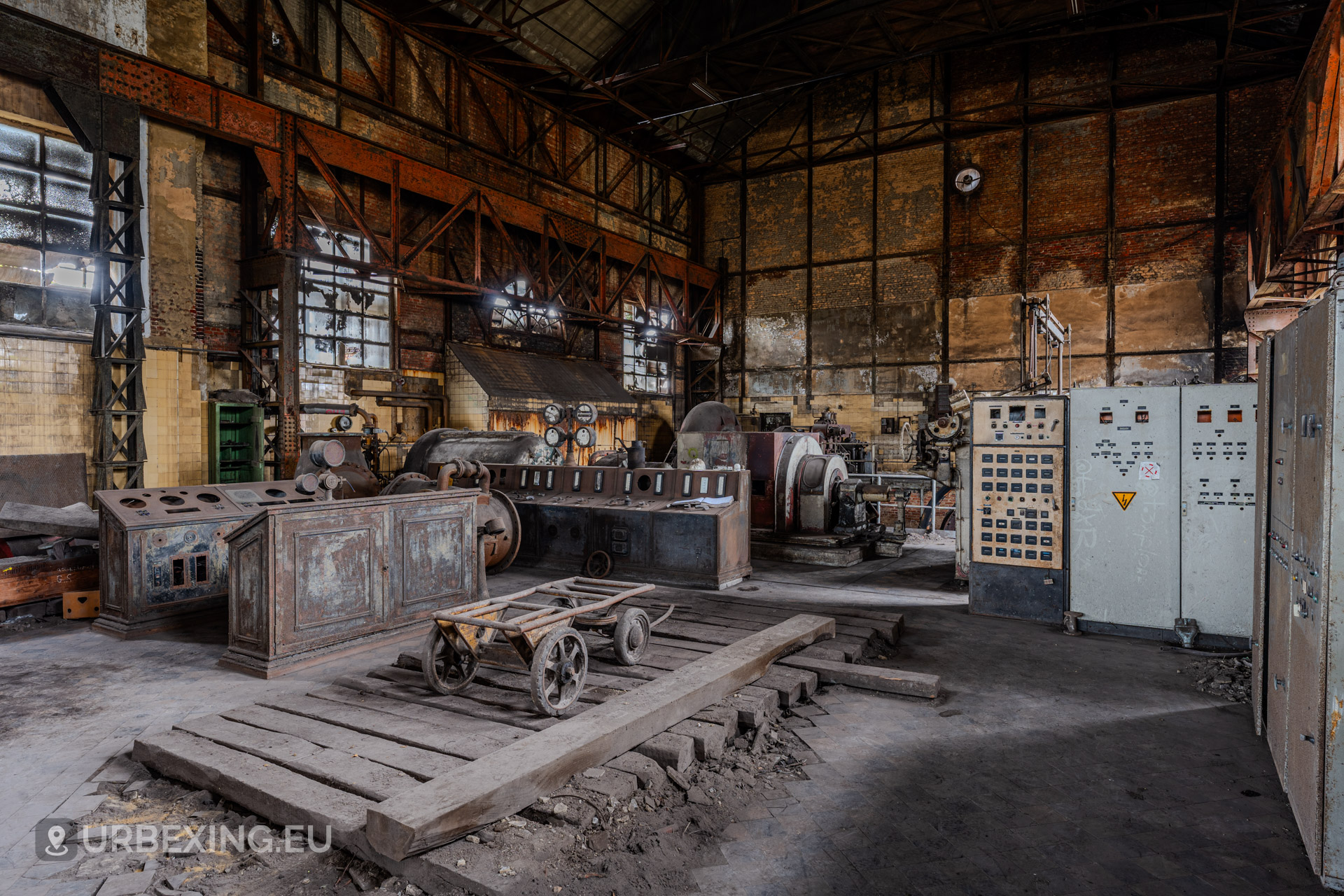Overview photograph of the turbine hall at the abandoned wet dogs power plant showcasing turbines and control panels